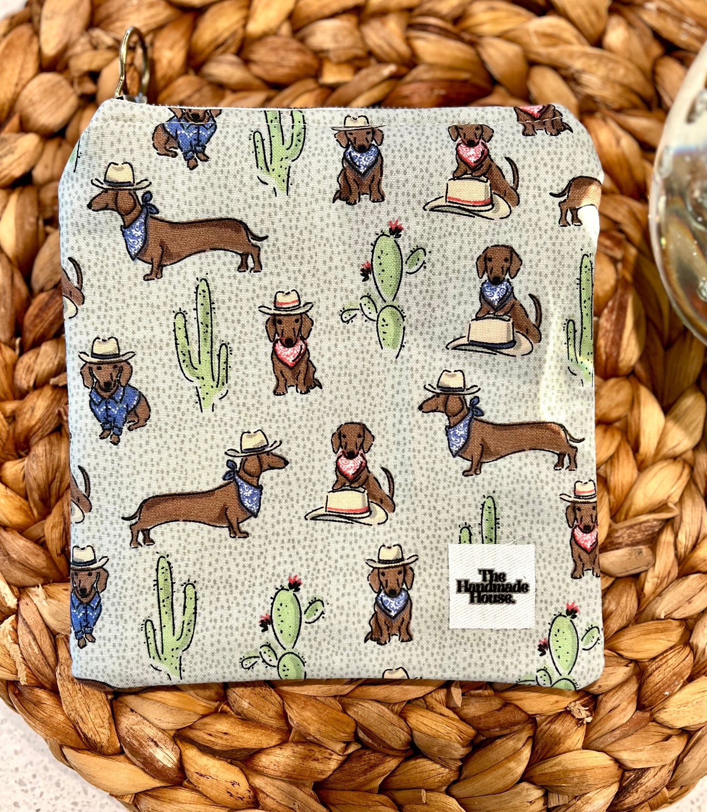 Dachshund Mini Pouch with Western-themed print on woven background.
