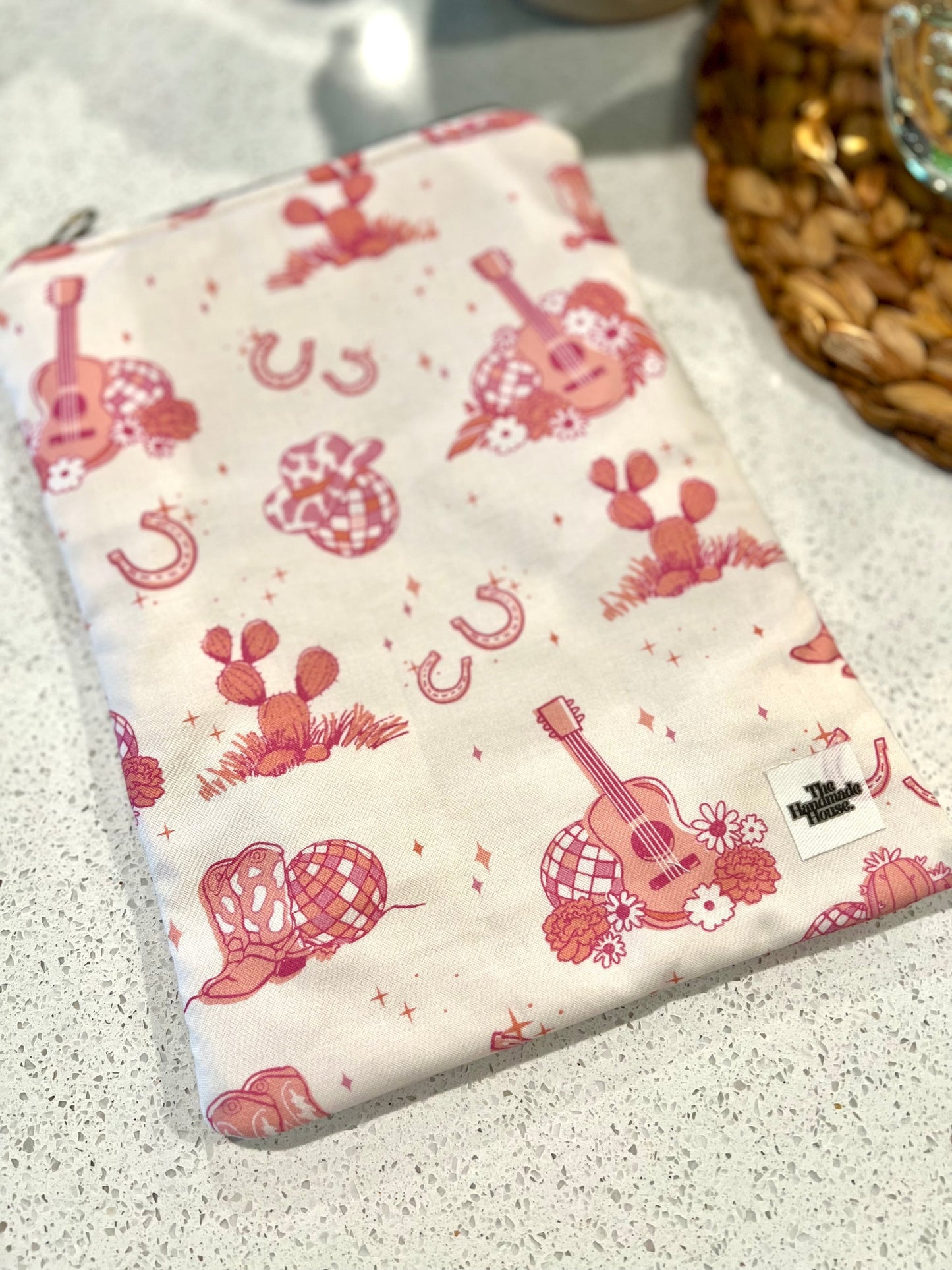 Handmade pink cowgirl cotton quilted book sleeve with zipper closure.
