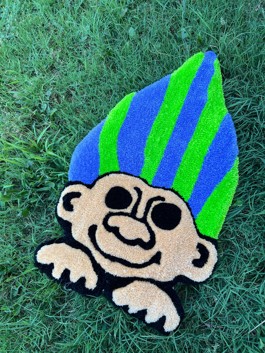 Neon Troll rug on grass, ready to ship.