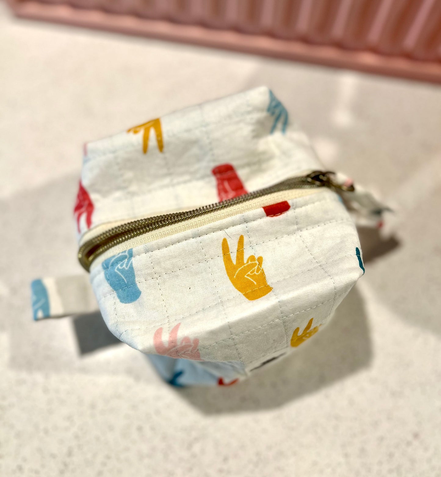 Handmade peace sign pouch with zipper closure for makeup or art supplies.