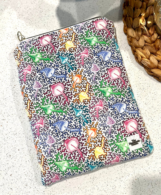 Handmade mushroom print quilted book sleeve with zipper closure.