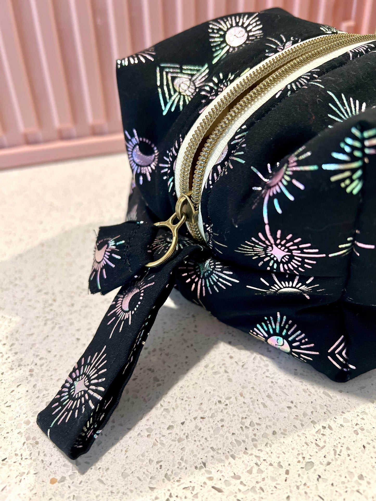 Handmade Witchy Pouch with zipper closure and pull tab, black fabric with mystical patterns.