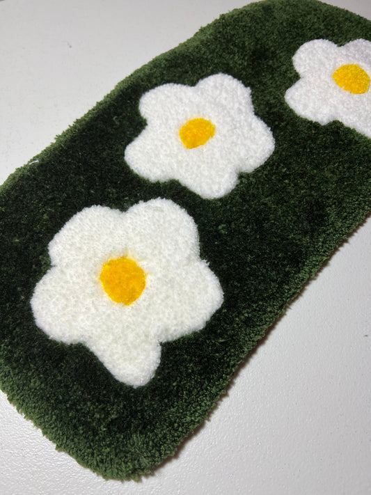 Flower garden computer mat with white and yellow flower design on green background.