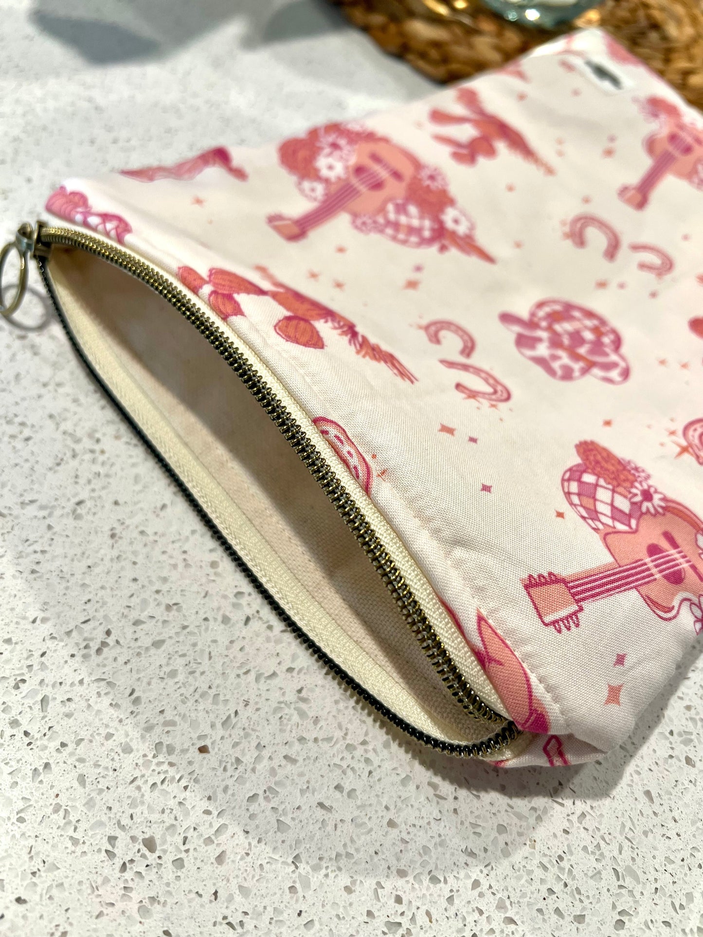 Handmade pink cowgirl small quilted book sleeve with zipper closure.
