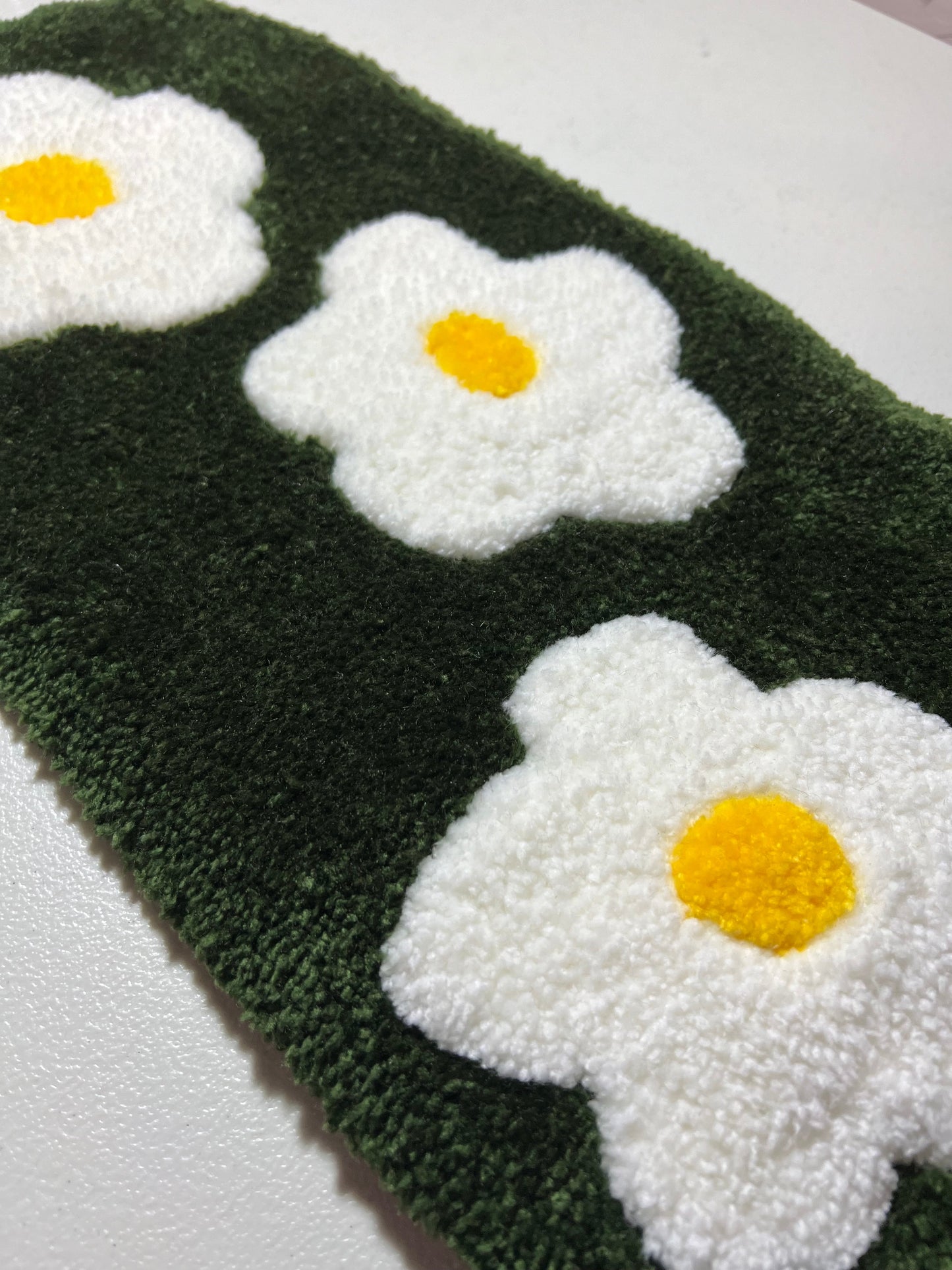 Flower garden computer mat with white daisies on a green background.