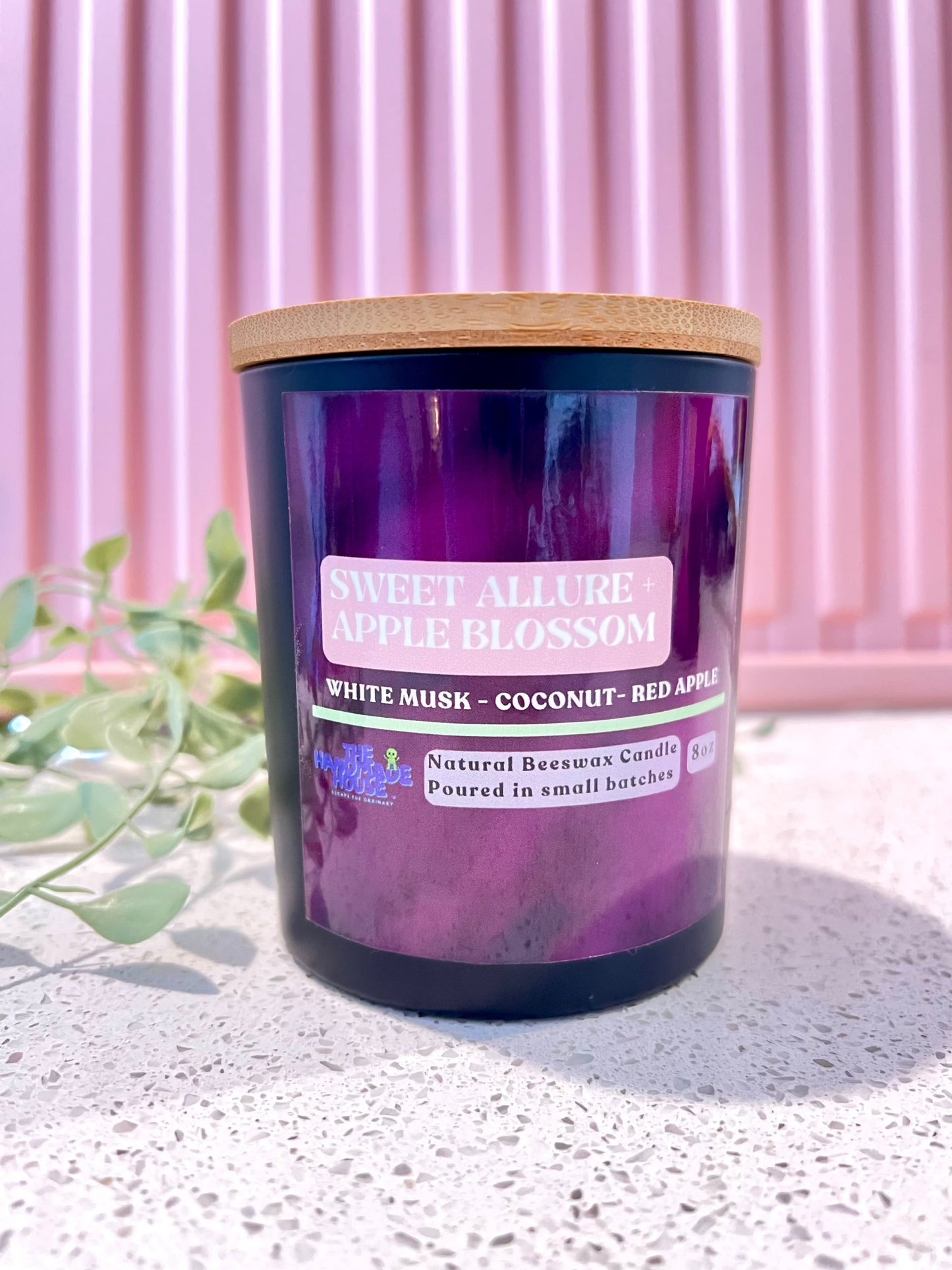 Sweet Allure Apple Blossom candle with white musk, coconut, and red apple notes; cruelty-free and paraffin-free beeswax with wooden wick.
