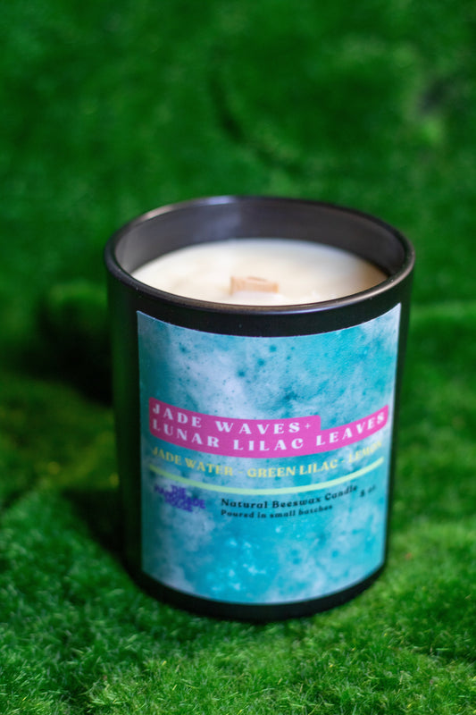 Natural beeswax candle with jade and lilac aroma in a minimalist vessel.