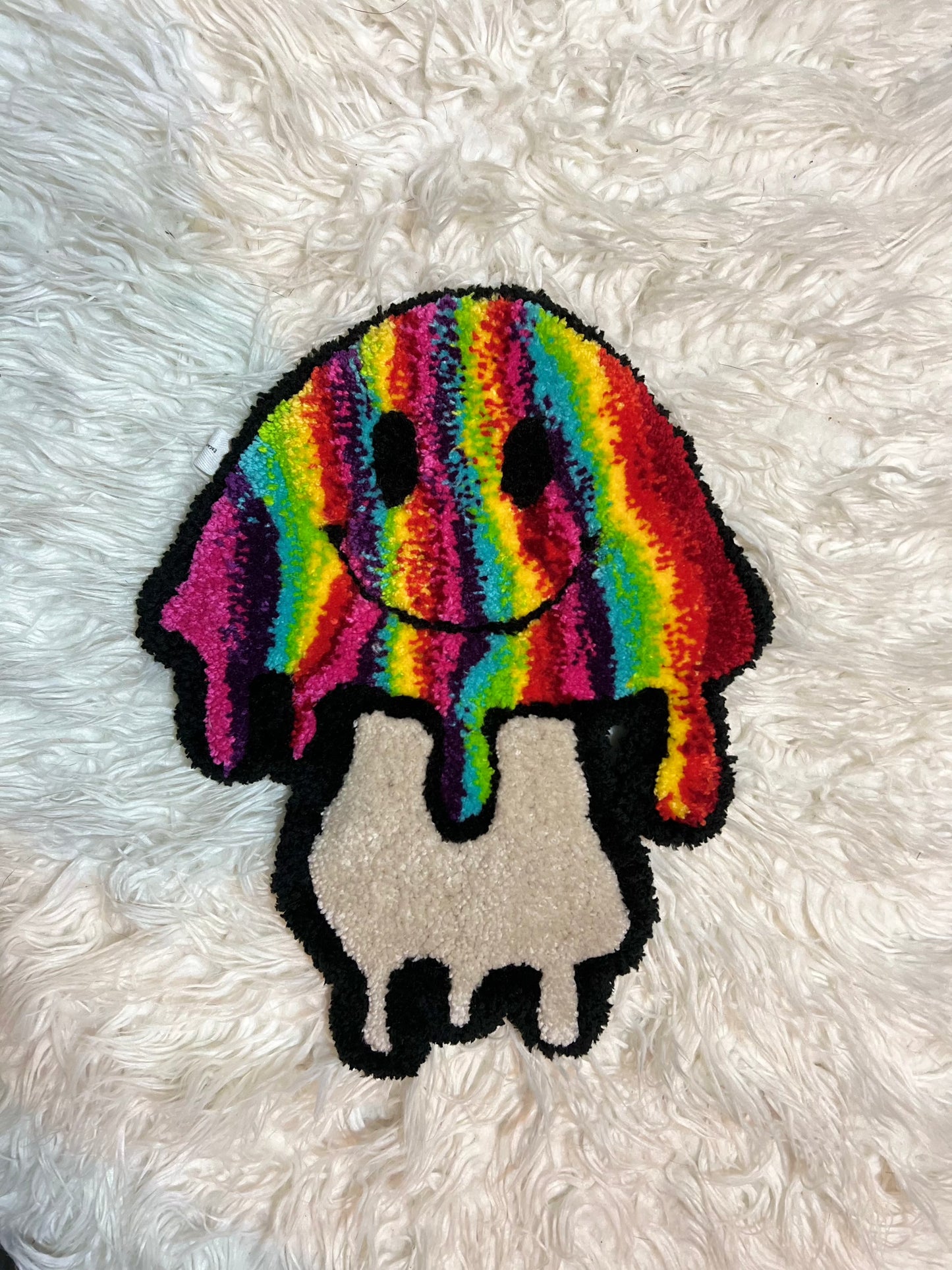 Colorful rainbow mushroom design on a plush fabric background, part of Drop 2 collection.
