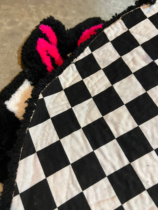 Checkered textile with pink and black accents from Drop 3 collection, size 21x24.