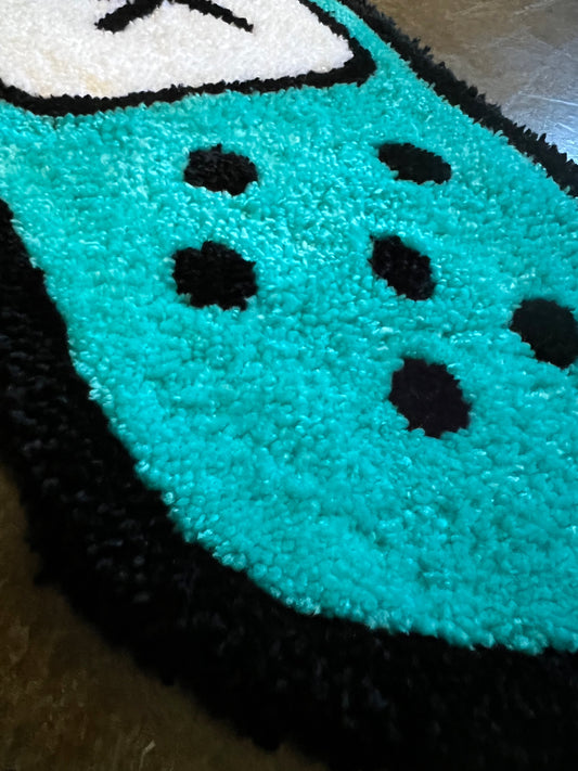 Drop 3 "I'm okay" bandaid rug with teal and black design.