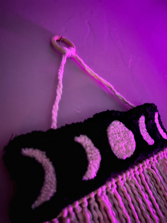 Wall hanging featuring moon phases in pink lighting, size 21x13 inches.