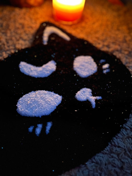 Spooky cat design in sparkle black and white, size 13x13 inches, with candlelight.