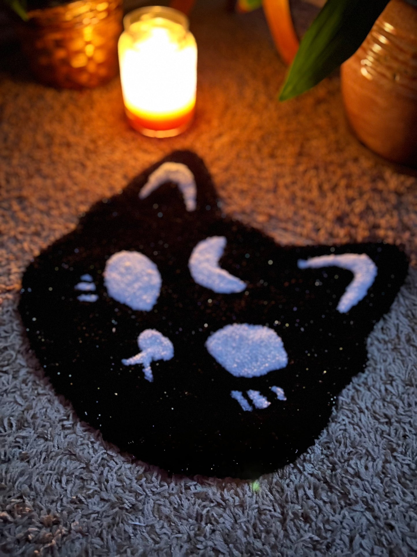 Spooky cat design in sparkle black and white, 13x13 inches, glowing in candlelight.