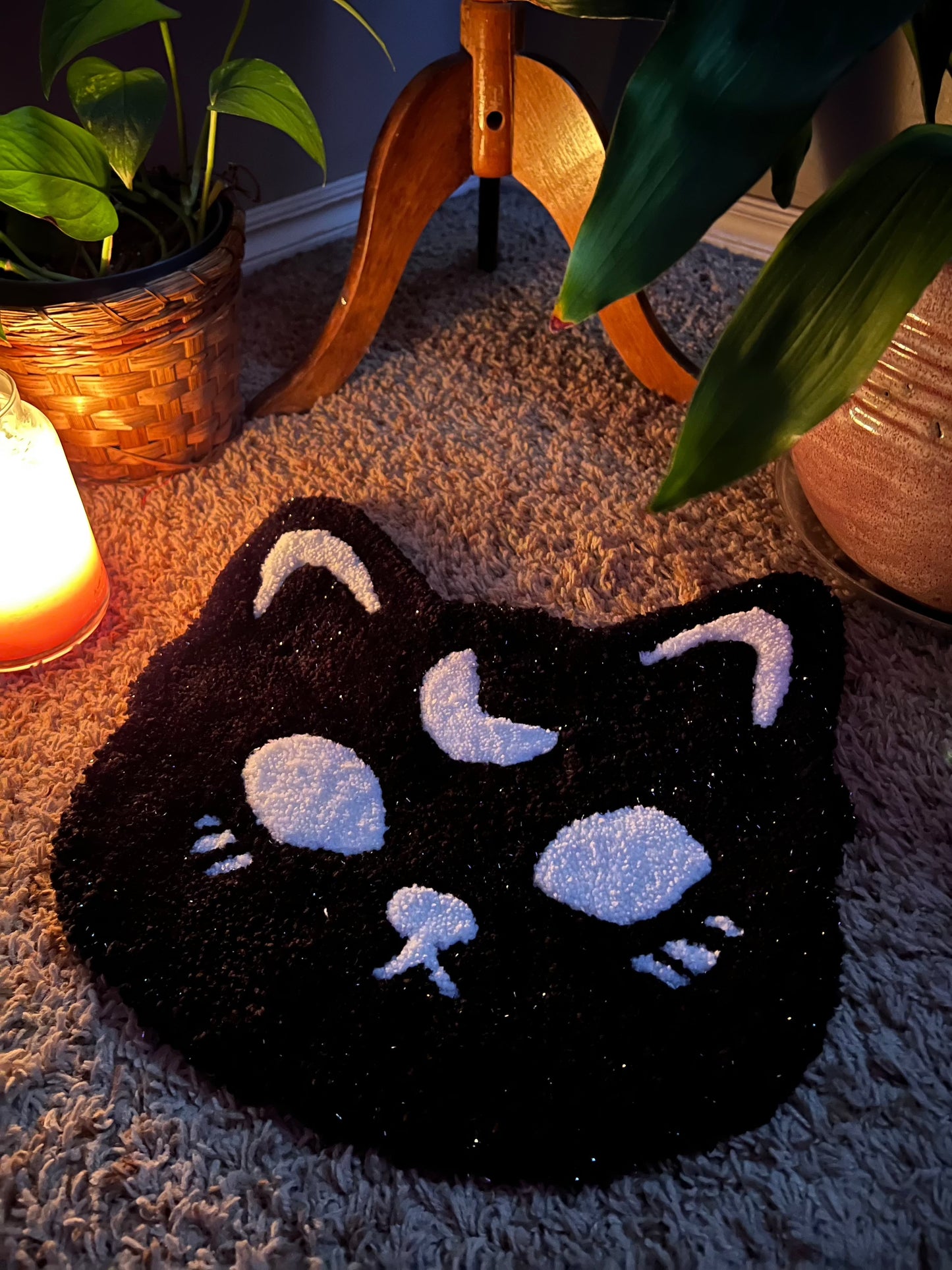 Spooky cat-shaped rug in sparkle black and white, 13x13 inches, on a cozy floor setting.