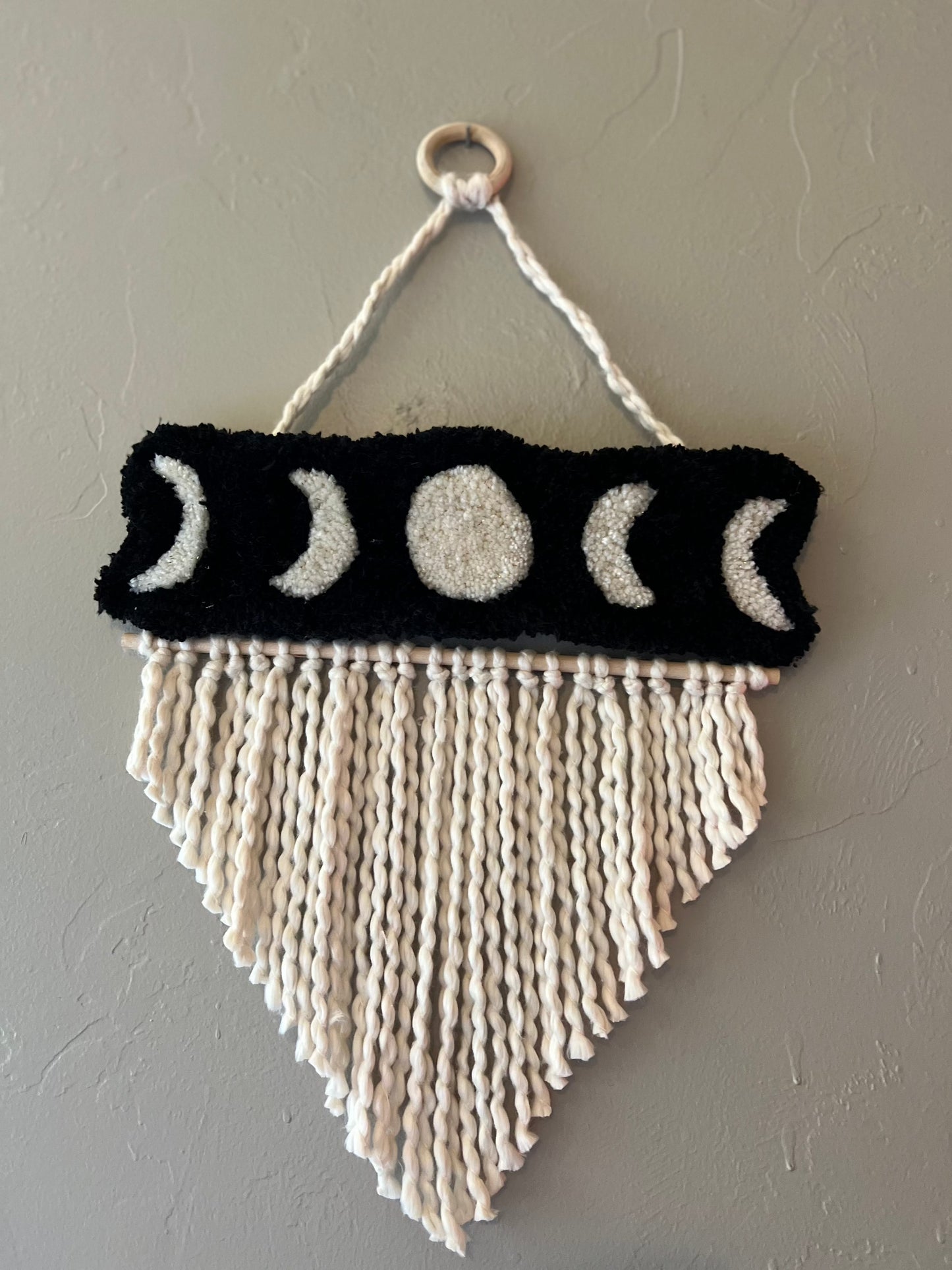 Wall hanging with moon phase design, size 21x13 inches.