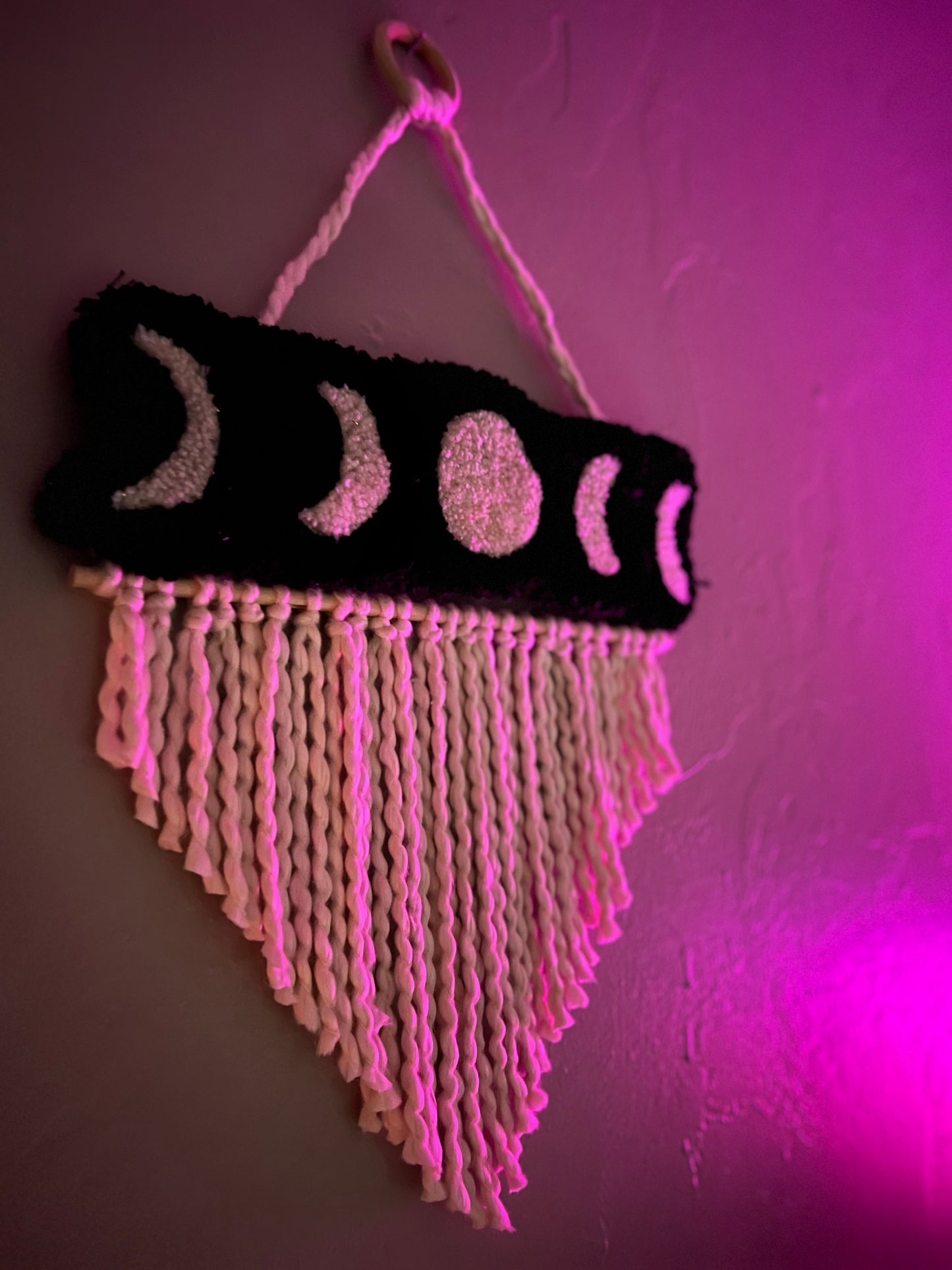 Wall hanging with moon phases design, size 21x13 inches.