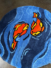 Koi fish design on a blue circular rug.