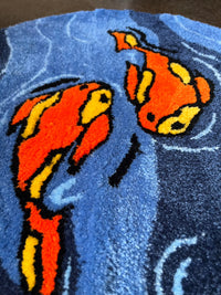 Vibrant Koi Fish design on textured textile background.
