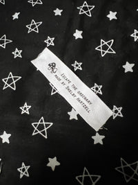 Koi Fish-themed fabric with stars and label reading "Escape the Ordinary" by Shelyn Martell.