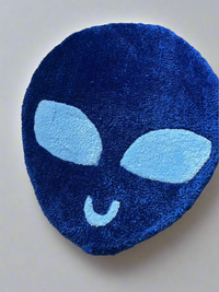 Blue alien-shaped rug ready for shipping.