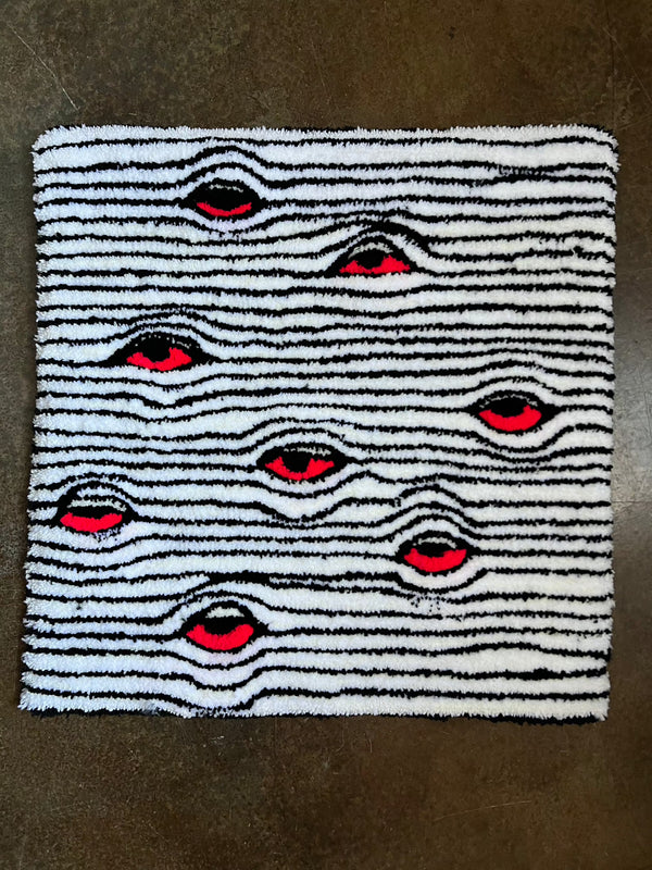 Striped Eyes Rug with red eye pattern, ready to ship.