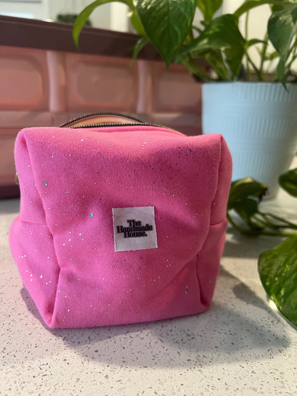 Pink handmade pouch with zipper closure, ideal for makeup or art supplies.