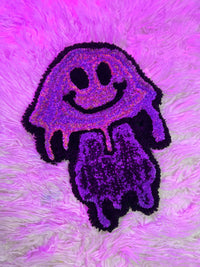 Purple mushroom rug with smiley face design on fluffy pink background, part of Drop 2 collection.