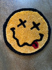 Classic Smiley Face rug with crossed eyes and red tongue, 12x12 inches.