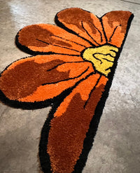 Colorful sunflower-shaped rug, 32x17 inches, part of Drop 3 collection.