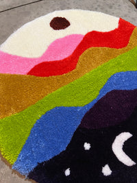 Colorful "Drop 3: Skyline" rug, 27x27, featuring vibrant abstract landscape design.