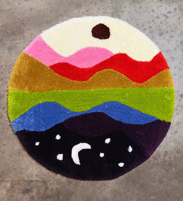 Colorful round rug with abstract skyline design, titled "Drop 3: Skyline," size 27x27.