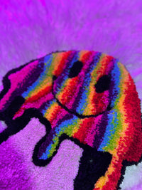 Rainbow mushroom design from Drop 2 collection with vibrant colors against a purple background.