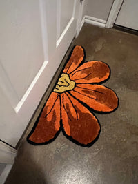 Sunflower-shaped rug, size 32x17, placed inside a doorway.