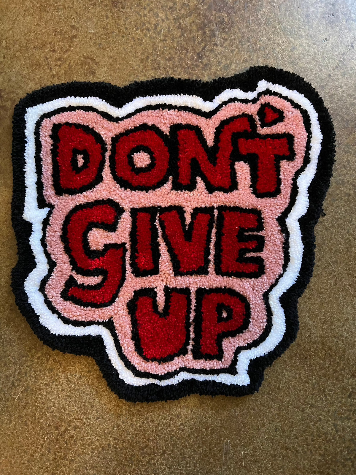 Tufted wall art with "Don't Give Up" design, size 16x15, Drop 3 collection.