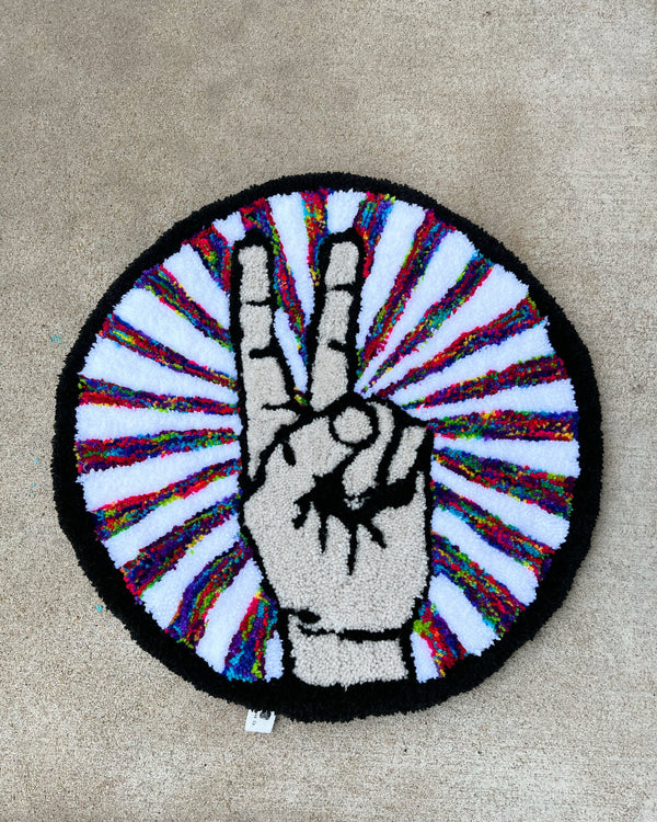 Peace Sign Rug in black, tan, and multicolor, 19x19 inches.