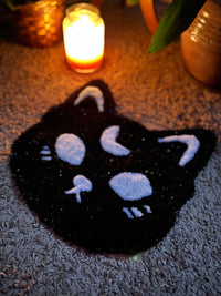 Spooky cat design in sparkle black and white, 13x13 inches, glowing in candlelight.